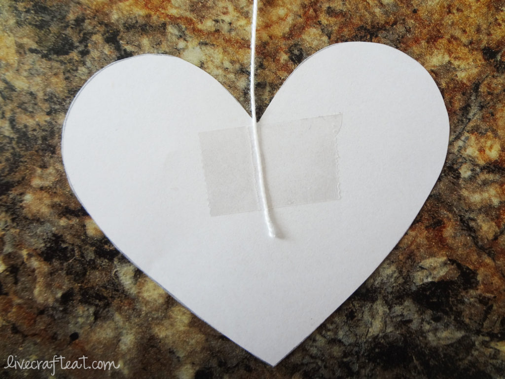 hanging hearts decoration using tape and paper and string