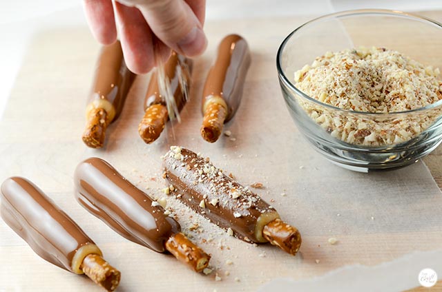 almond-covered chocolate caramel pretzel rods