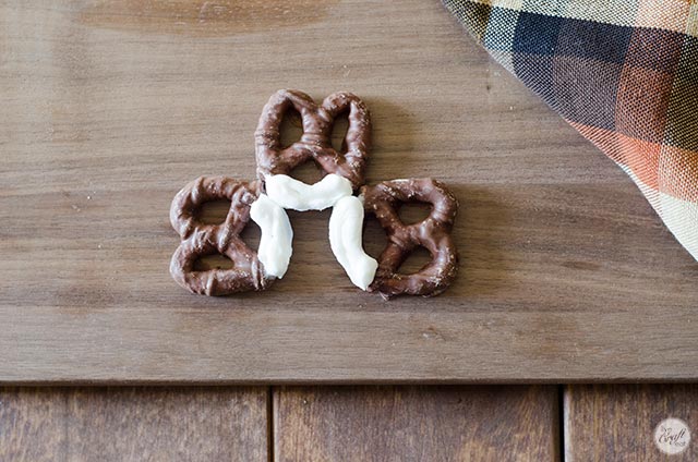 icing glue on chocolate pretzels